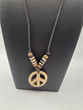 1689. Carved Bone Peace Sign Pendant Necklace On A Leather Cord